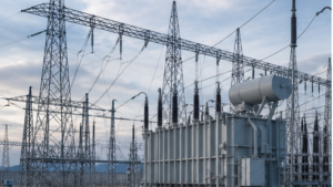 High-voltage transmission lines entering a substation with power transformer