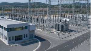 Nearly completed electrical substation with transformers, switchyard bays and control building